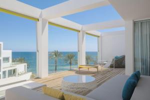 a living room with a view of the ocean at W Ibiza in Santa Eularia des Riu