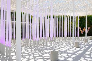 a rendering of a white room with white poles at W Ibiza in Santa Eularia des Riu