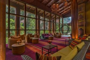 a living room with couches and tables and windows at Tambo del Inka, a Luxury Collection Resort & Spa, Valle Sagrado in Urubamba