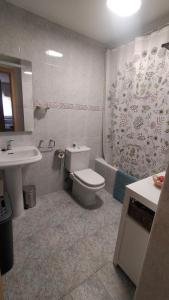 a bathroom with a toilet and a sink and a tub at Peñas de Arnedillo in Arnedillo