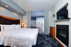 a hotel room with a bed and a flat screen tv at Fairfield Inn & Suites Santa Cruz - Capitola in Capitola