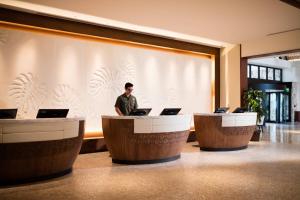 a man sitting at a desk with a laptop at JW Marriott Marco Island Beach Resort in Marco Island