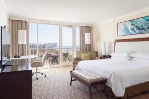 a hotel room with a bed and a balcony at JW Marriott Marco Island Beach Resort in Marco Island