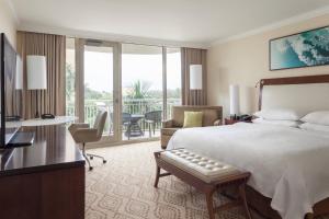 a hotel room with a bed and a balcony at JW Marriott Marco Island Beach Resort in Marco Island