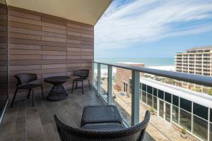 a balcony with chairs and tables and a view of the ocean at JW Marriott Marco Island Beach Resort in Marco Island