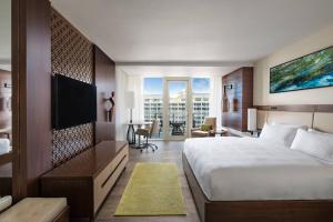 a hotel room with a large bed and a television at JW Marriott Marco Island Beach Resort in Marco Island