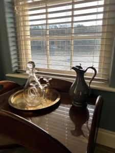 a table with two glass jars and a vase on it at Oystercatcher in Fowey