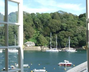a view of boats in the water from a window at Oystercatcher in Fowey +7 photos