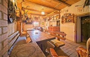 a dining room with a wooden table and chairs at Awesome Home In Prodin Dol in Ivančići