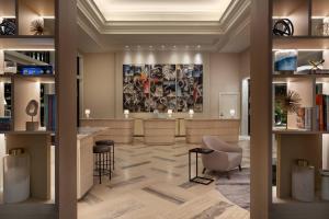 a lobby with a library with a bar and chairs at JW Marriott Miami Turnberry Resort & Spa in Aventura