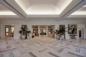 an empty lobby with potted plants and a ceiling at JW Marriott Miami Turnberry Resort & Spa in Aventura