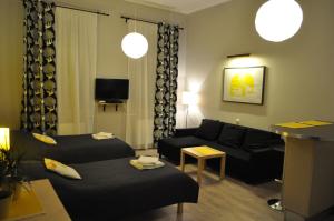 a living room with a couch and a living room with at Apartamenty Sedinum in Szczecin
