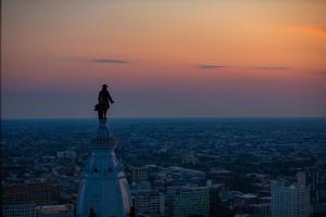 a statue of a man standing on top of a building at W Philadelphia in Philadelphia