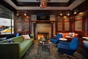 a living room with a couch and chairs and a fireplace at Sheraton New York Times Square Hotel in New York