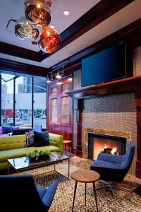 a living room with a fireplace and a tv at Sheraton New York Times Square Hotel in New York