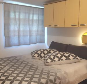a bed with two pillows on it in a room at grabrova cove in Novi Vinodolski