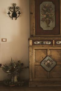 a wooden cabinet with a clock on top of it at Casa Acquariana in Belluno