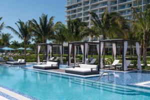 a swimming pool with lounge chairs and a hotel at The Ritz-Carlton, Turks & Caicos in Providenciales