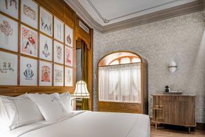 um quarto com uma grande cama branca e uma janela em Palacio Santa Clara, Autograph Collection em Valência
