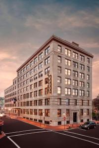 a large building on the corner of a street at The Press Hotel, Autograph Collection in Portland