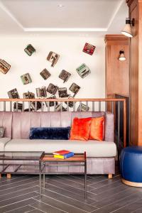 a living room with a couch and books on the wall at The Press Hotel, Autograph Collection in Portland