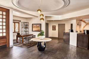 a living room with a table and a kitchen at ADERO Scottsdale Resort, Autograph Collection in Scottsdale