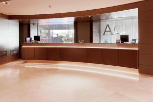 a large lobby with a bar in a building at AC Hotel Gran Canaria by Marriott in Las Palmas de Gran Canaria