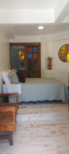 a bedroom with a large bed and two stained glass windows at Pousada Charitas Saint Malo in Niterói