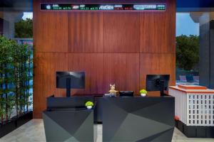 a lobby with two desks and a wooden wall at Aloft Orlando Downtown in Orlando