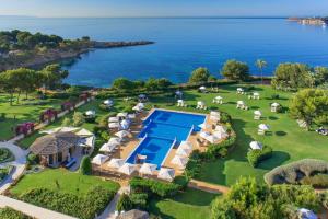 an aerial view of a resort with a swimming pool and the ocean at The St. Regis Mardavall Mallorca Resort in Portals Nous
