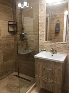 a bathroom with a sink and a shower at Apartament Nicolle in Poiana Brasov