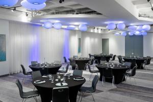 a room with black tables and chairs and blue lights at Aloft by Marriott Orlando Downtown in Orlando +49 photos