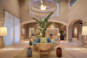 a lobby with a couch and a potted plant at Hacienda Son Antem Golf Resort, Autograph Collection in Llucmajor