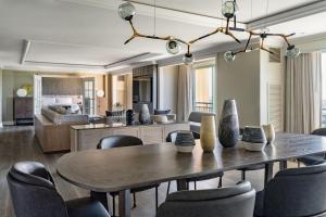 a dining room and living room with a table and chairs at JW Marriott Orlando Grande Lakes in Orlando