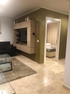 a living room with a couch and a bed at Apartament Nicolle in Poiana Brasov
