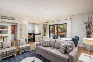 a living room with a couch and chairs at Sheraton Cascais Resort - Hotel & Residences in Cascais