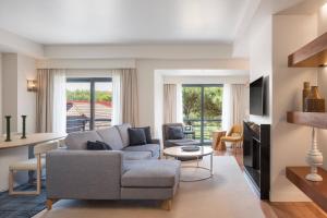 a living room with a couch and a table at Sheraton Cascais Resort - Hotel & Residences in Cascais