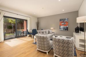a living room with a couch and chairs at Sheraton Cascais Resort - Hotel & Residences in Cascais