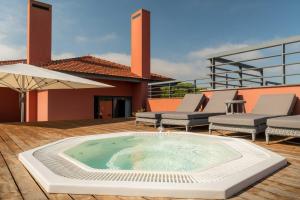 a hot tub on the deck of a house at Sheraton Cascais Resort - Hotel & Residences in Cascais