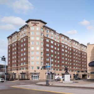 a large brick building with a statue in front of it at Residence Inn Pittsburgh North Shore in Pittsburgh