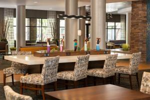 a dining room with a table and chairs at Courtyard by Marriott Scottsdale Salt River in Scottsdale