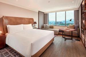 a hotel room with a large bed and a couch at JW Marriott Hotel Seoul in Seoul