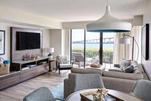 a living room with a couch and a tv at Coronado Island Marriott Resort & Spa in San Diego