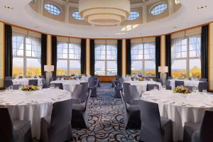 a ballroom with white tables and chairs and windows at Sheraton Sopot Hotel in Sopot +37 photos