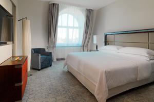 a hotel room with a large bed and a window at Sheraton Sopot Hotel in Sopot