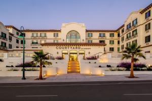 a building with the front entrance to a court yard at Courtyard by Marriott Santa Cruz in Santa Cruz