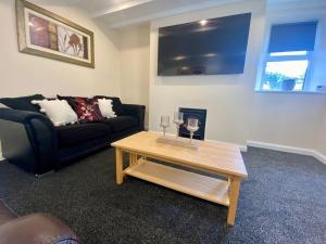 a living room with a couch and a coffee table at Mountain Dream Ramsey Isle of Man in Ramsey