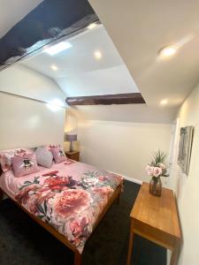 a bedroom with a bed and a wooden table at Mountain Dream Ramsey Isle of Man in Ramsey