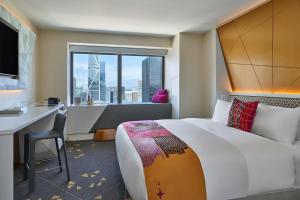 a hotel room with a bed and a desk and a window at W San Francisco in San Francisco