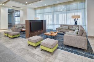 a lobby with couches and a tv and chairs at Courtyard By Marriott El Paso Downtown/Convention Center in El Paso